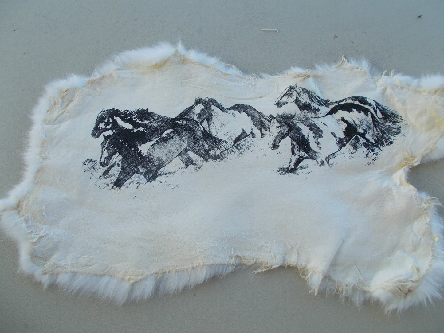 Real nice, printed running horses print on white rabbit fur measures 18" x 11"